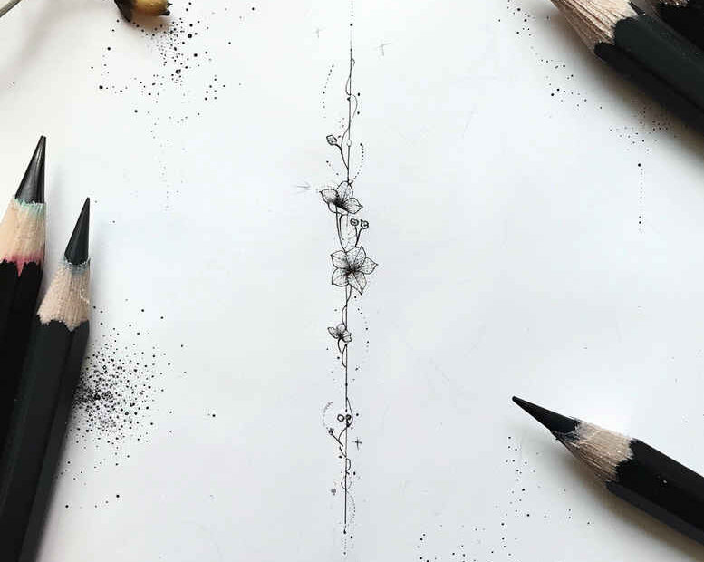 Vertical lotus along a slender stem with beads and ornaments in black and grey; tattoo design concept.