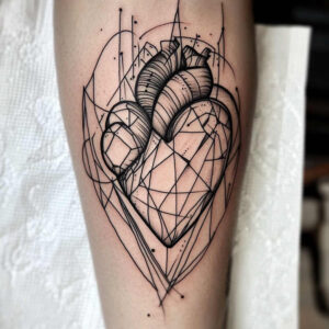 Heart and flower visible in black ink with geometric linework; black and grey; a tattoo project; not a cover-up.