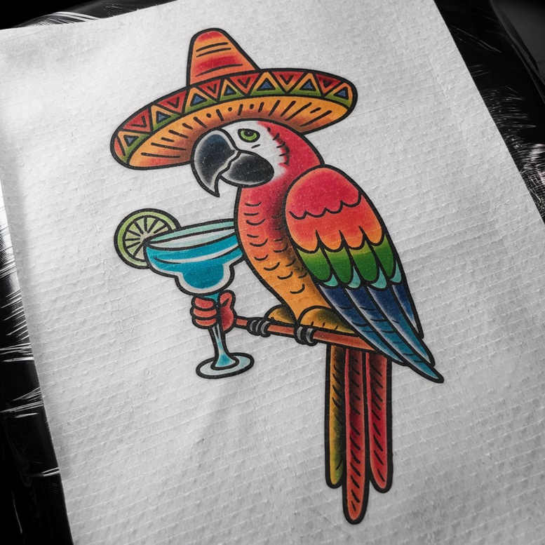 Colorful parrot wearing a multicolor sombrero, perched on a rod and holding a blue margarita glass with a lime slice; bold, full-color tattoo project with pattern elements.