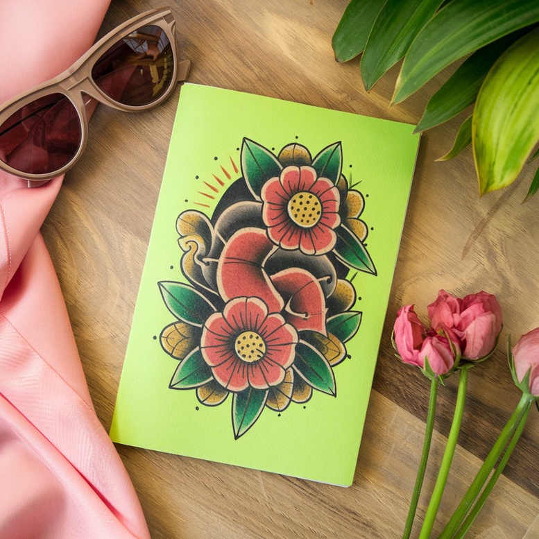 Card with neon green background showing a bold, full-color floral tattoo design with red-pink flowers, green leaves, and black outlines; visible: sunglasses, pink fabric, pink tulips; project idea; not intended as a cover-up.
