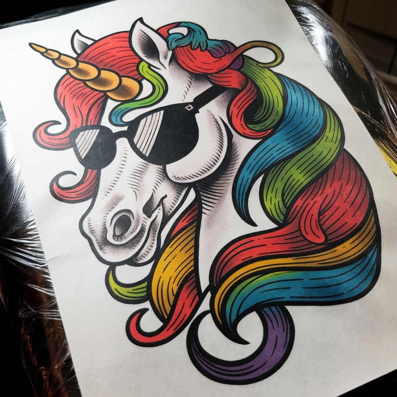 Unicorn head tattoo design in full color with rainbow mane, horn, and sunglasses; AI-generated tattoo project.