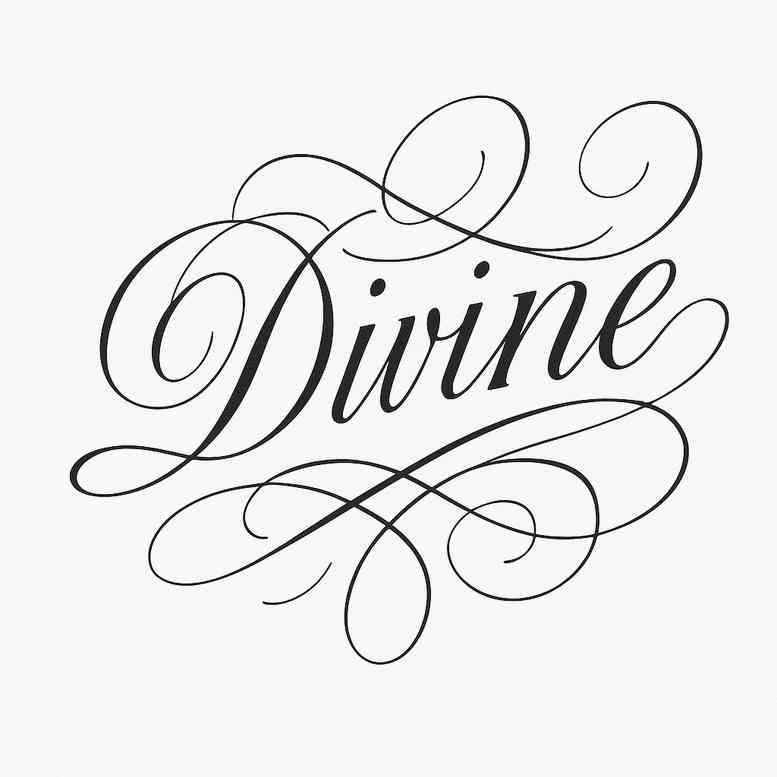 Divine script tattoo in black ink with ornate curls and flourishes, a black and grey project concept suitable for cover-up consideration.