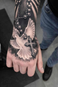 Dove and rosary tattoo on the foot in black and grey; project idea.