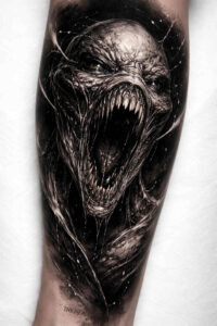 Demon creature head with an open mouth in black and grey realism; a project concept tattoo design, highly cover-up ready.