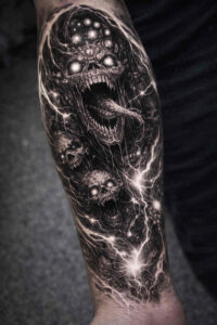 Black-and-grey cosmic dragon sleeve on forearm; a project idea with cover-up potential.