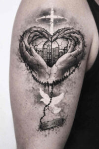 Two hands form a heart around a central heart with a cross above, in black and grey; a project idea for tattoo design.