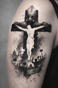 Crucifix with Jesus on the cross in a dark black-and-grey heavy blackwork tattoo, a project idea, perfect for a cover-up.